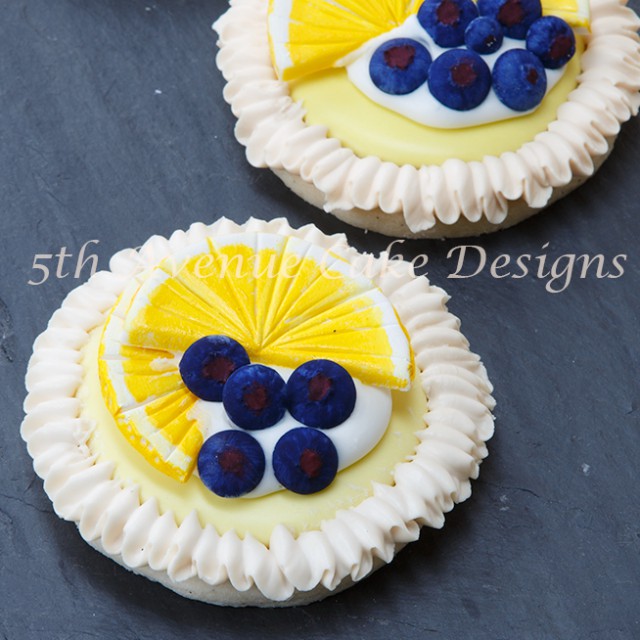Learn how to make Lemon Meringue Cookies with Royal Icing blueberries and lemon slices!