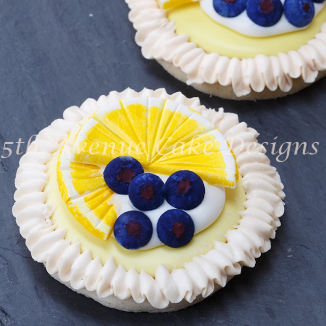 Learn how to make Lemon Meringue Cookies with Royal Icing blueberries and lemon slices!